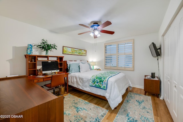 bedroom with a closet, ceiling fan, and light hardwood / wood-style flooring