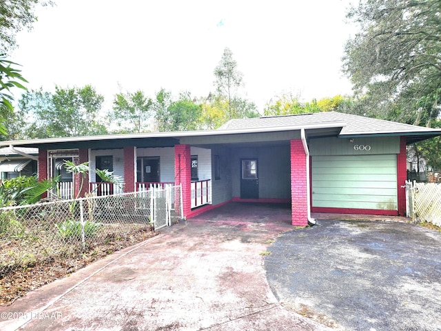 single story home featuring covered porch, a garage, and a carport