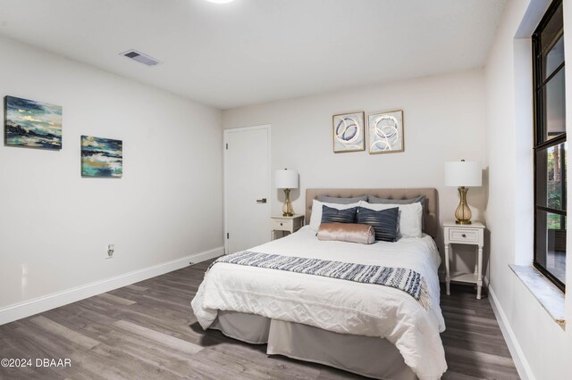 kitchen featuring white cabinets, light hardwood / wood-style floors, stainless steel refrigerator with ice dispenser, and vaulted ceiling