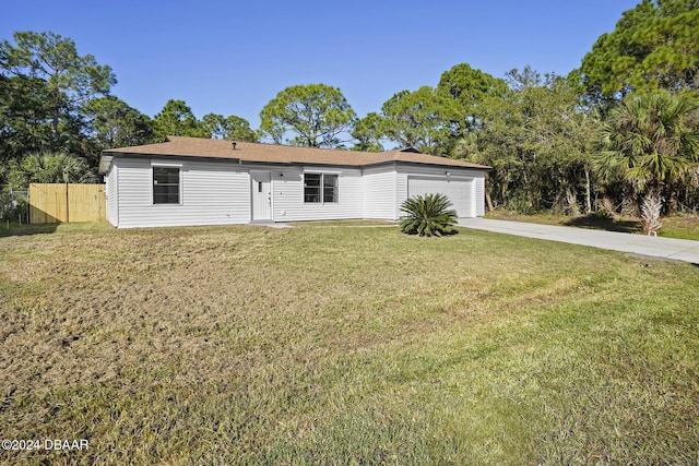 view of front of home with a front yard and a garage