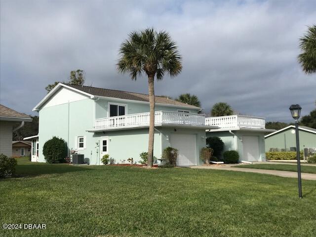 front facade featuring central AC unit and a front lawn