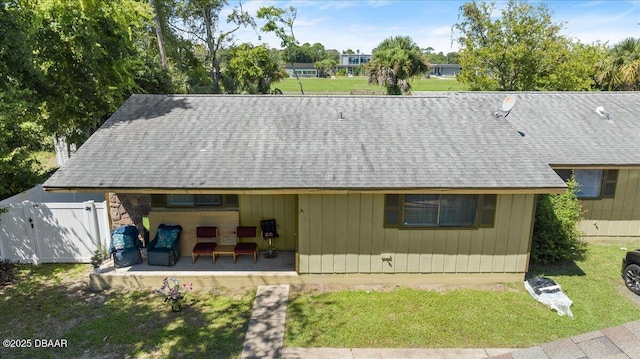 644 Lpga Blvd Unit A, Daytona Beach, FL 32117 - back of property featuring roof with shingles and a gate