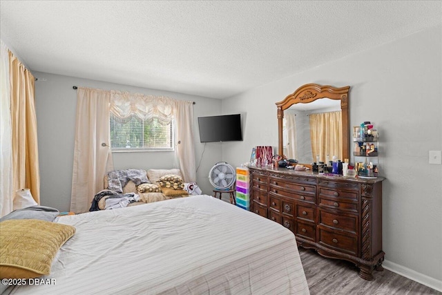 644 Lpga Blvd Unit A, Daytona Beach, FL 32117 - bedroom with wood finished floors, baseboards, and a textured ceiling