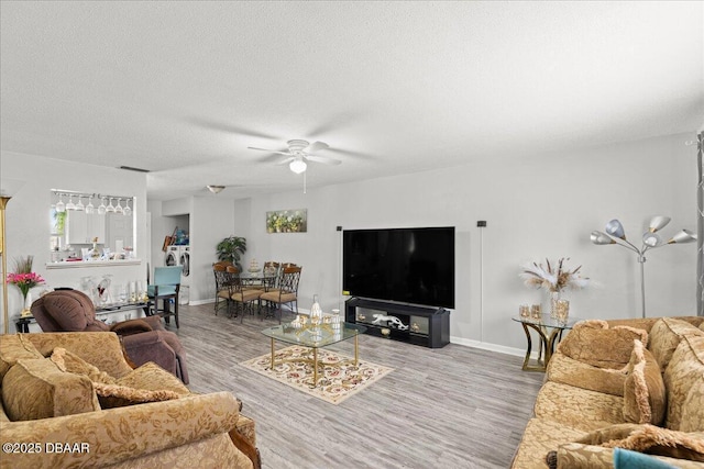 644 Lpga Blvd Unit A, Daytona Beach, FL 32117 - living area with ceiling fan, light wood-type flooring, baseboards, and a textured ceiling