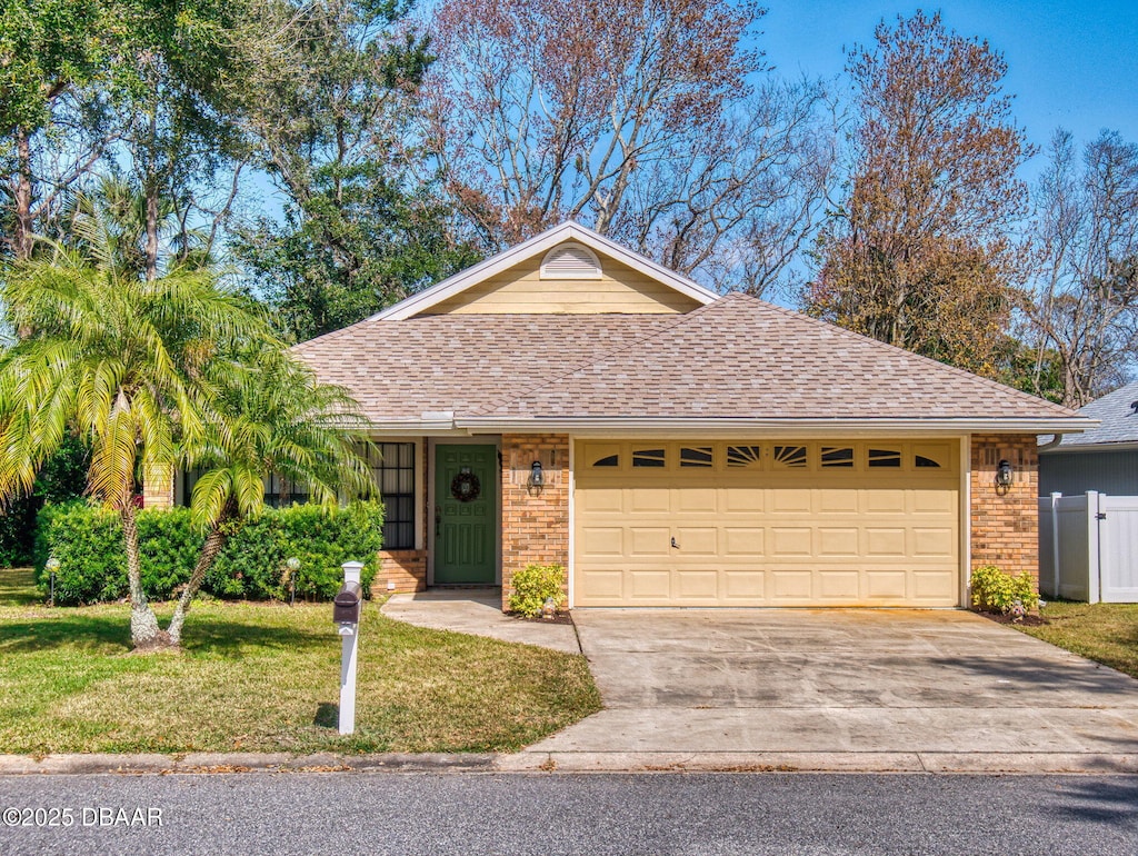 single story home with a garage and a front yard