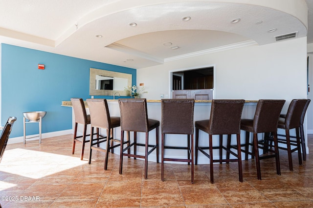 interior space featuring crown molding and a raised ceiling