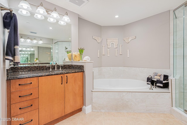 bathroom featuring vanity, independent shower and bath, and tile patterned flooring