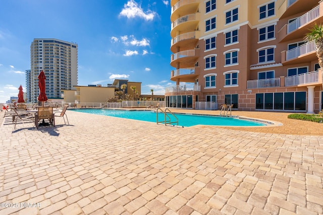 view of swimming pool with a patio area