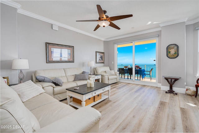 living room featuring crown molding, ceiling fan, and light hardwood / wood-style floors