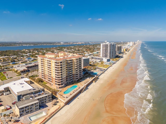 birds eye view of property with a water view and a view of the beach