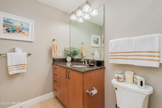 bathroom featuring vanity, tile patterned floors, and toilet