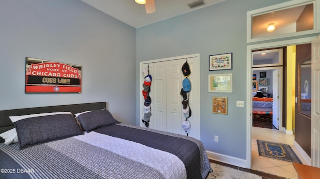 tiled bedroom featuring visible vents, baseboards, a closet, and a ceiling fan