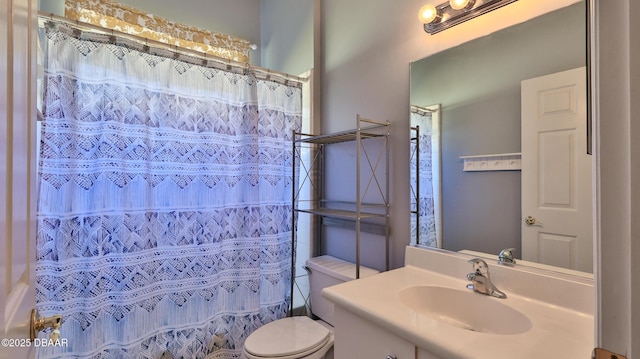 bathroom with toilet, vanity, and a shower with curtain