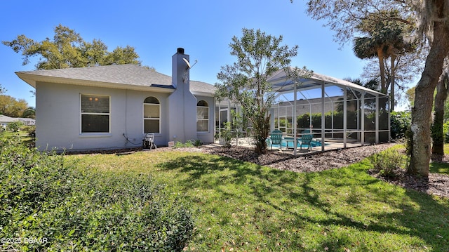 rear view of house featuring a lawn, glass enclosure, roof with shingles, an outdoor pool, and a chimney