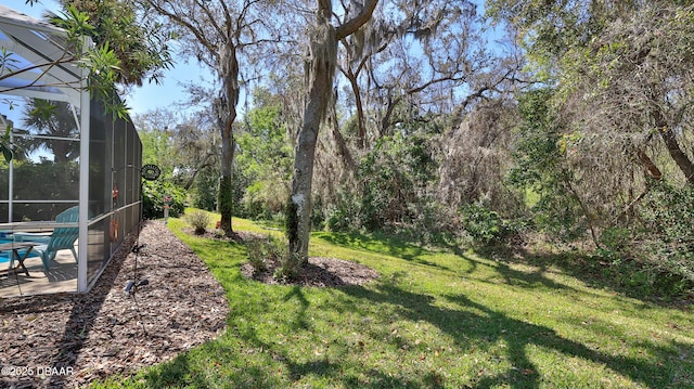 view of yard with a lanai, an outdoor pool, and a patio