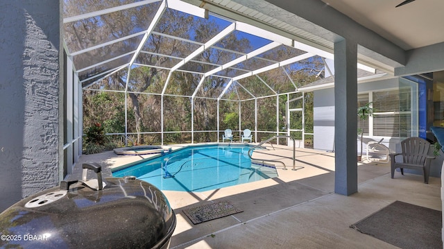 view of swimming pool featuring a sink, a patio, a lanai, and a pool with connected hot tub