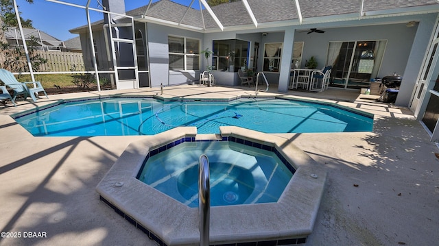 view of swimming pool with a lanai, ceiling fan, and a patio