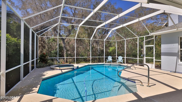 view of swimming pool with glass enclosure, a patio, and a pool with connected hot tub