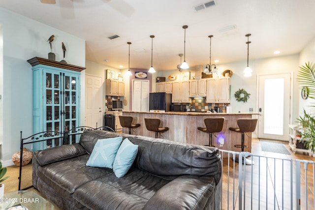 living room featuring hardwood / wood-style flooring and ceiling fan