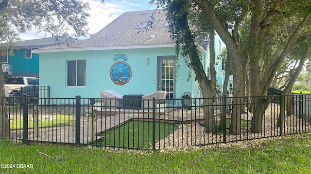 rear view of house featuring a yard and a patio area