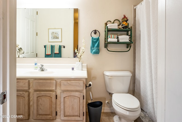 bathroom with tile patterned floors, vanity, and toilet