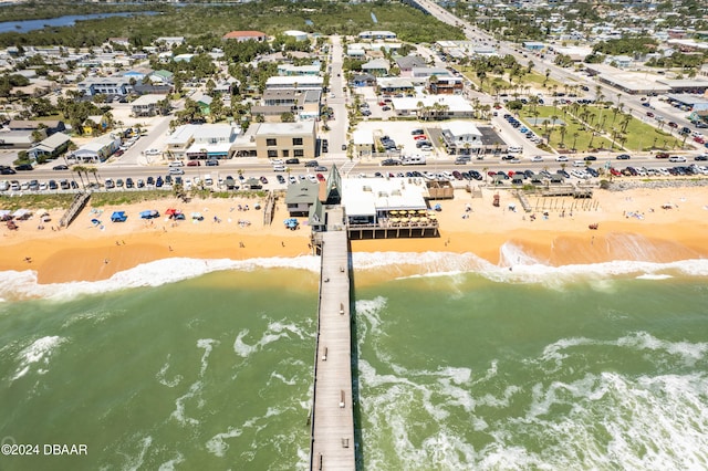 bird's eye view featuring a water view and a beach view