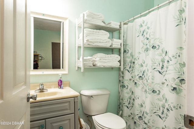 bathroom with vanity, toilet, and a shower with shower curtain