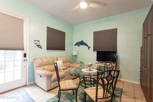 tiled dining area with ceiling fan