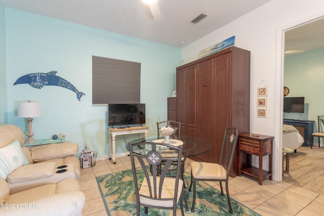 dining space with ceiling fan and light tile patterned flooring