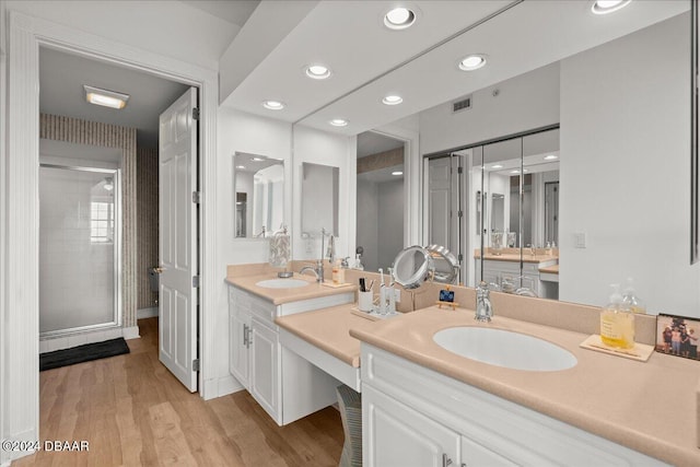 bathroom featuring walk in shower, wood-type flooring, and vanity