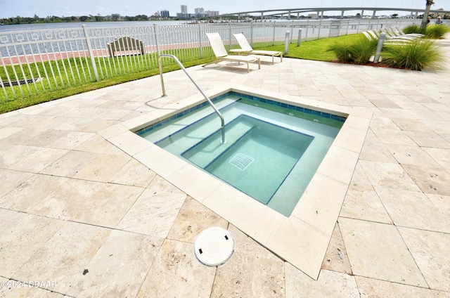 view of pool featuring a lawn, a patio, and an in ground hot tub