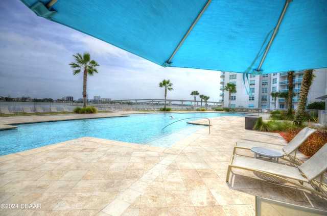 view of swimming pool with a patio