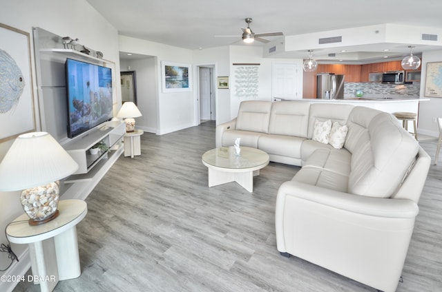 living room featuring hardwood / wood-style flooring and ceiling fan