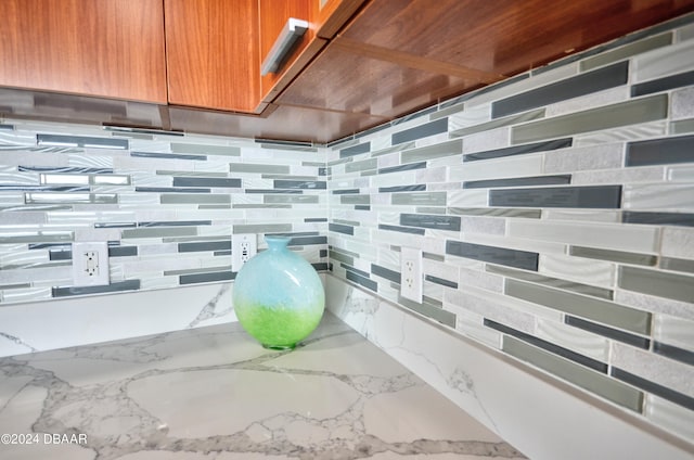 room details featuring light stone counters and backsplash