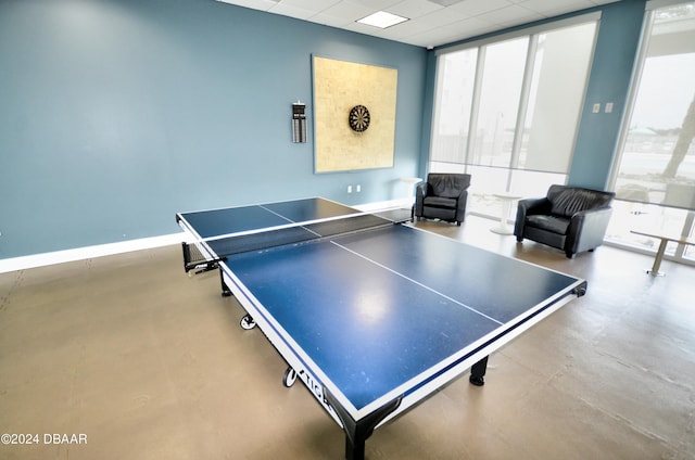 recreation room featuring a drop ceiling