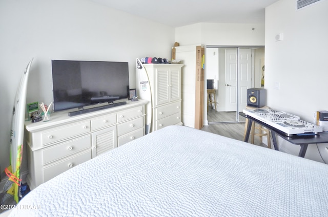 bedroom featuring hardwood / wood-style flooring and a closet