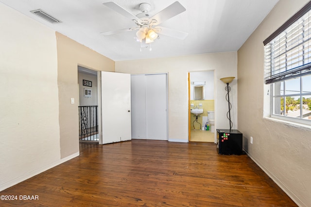 unfurnished room with dark hardwood / wood-style flooring and ceiling fan