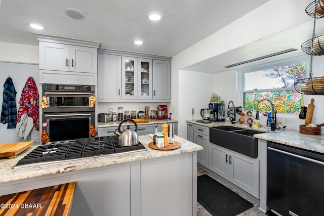 kitchen featuring gray cabinets, light stone countertops, sink, and appliances with stainless steel finishes