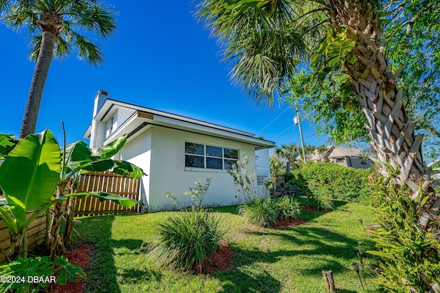 view of property exterior with a lawn