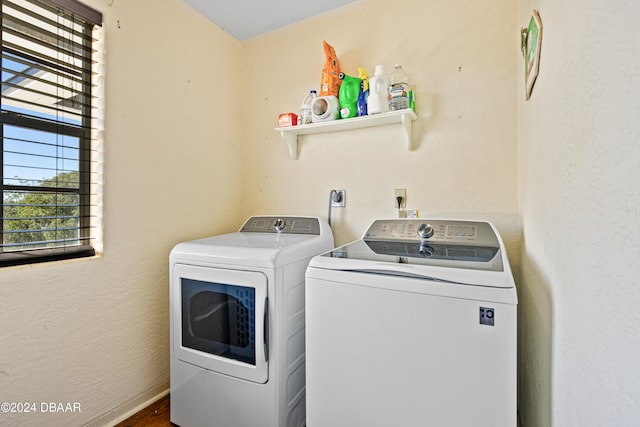 washroom with washer and clothes dryer and hardwood / wood-style flooring