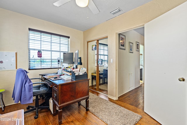 office with wood-type flooring and ceiling fan