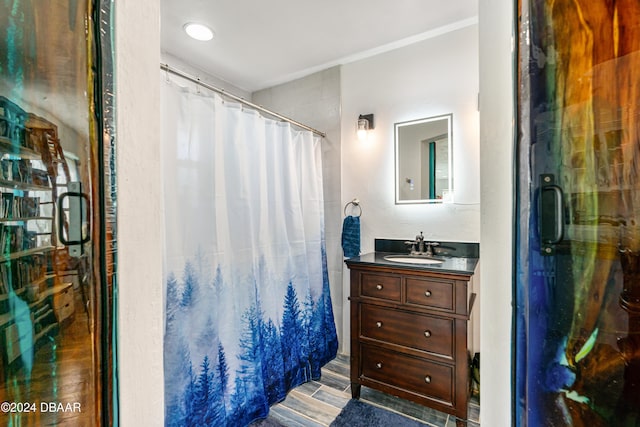 bathroom featuring curtained shower, vanity, and hardwood / wood-style flooring