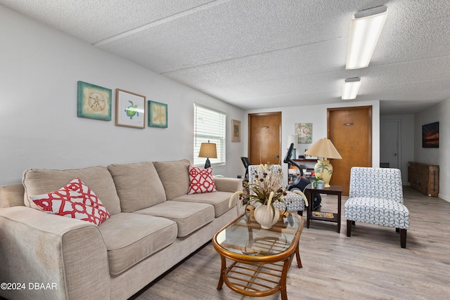 living room featuring a textured ceiling and hardwood / wood-style flooring