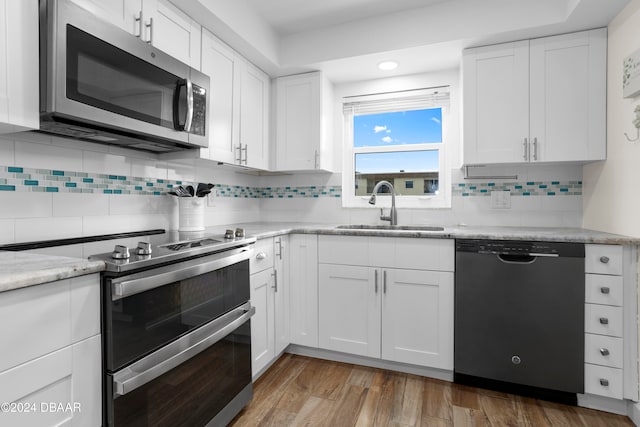 kitchen with white cabinetry, sink, and appliances with stainless steel finishes