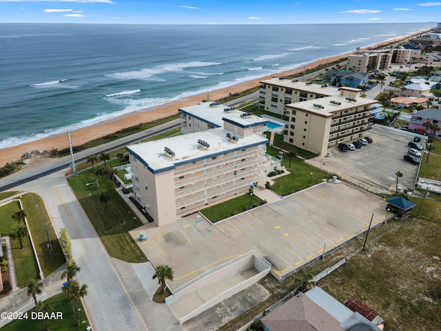 drone / aerial view featuring a water view and a beach view