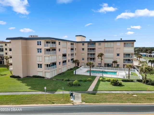 view of building exterior featuring a community pool