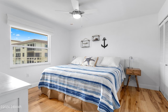 bedroom with ceiling fan, a closet, and hardwood / wood-style flooring