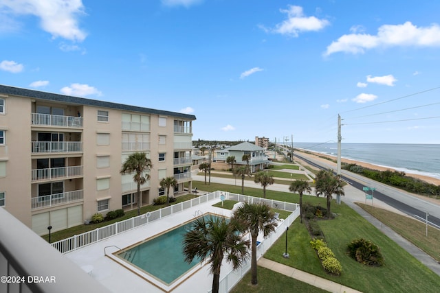 view of swimming pool featuring a water view