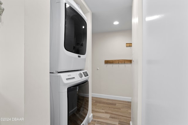 washroom featuring light wood-type flooring and stacked washer / drying machine