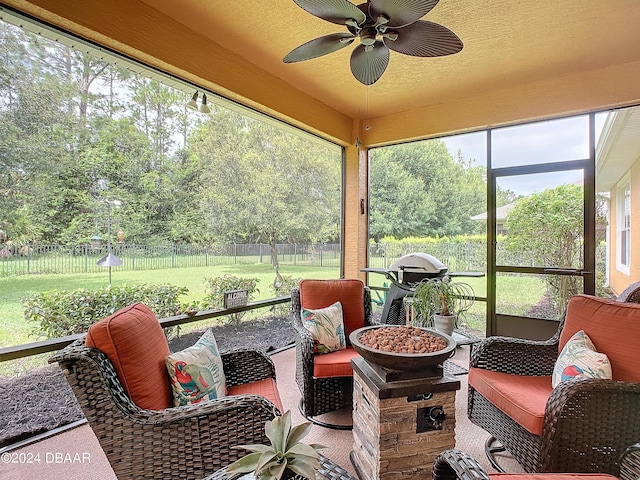 645 Elk River Dr, Ormond Beach, FL 32174 - sunroom featuring plenty of natural light, an outdoor living space with a fire pit, and a ceiling fan